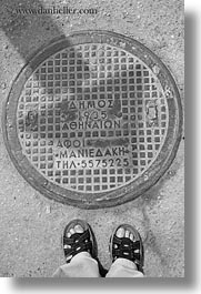 athens, black and white, covers, europe, feet, greece, manholes, streets, vertical, photograph