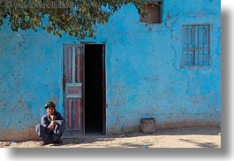 images/Africa/Egypt/AlKab/Village/squatting-man-n-blue-bldg-02.jpg
