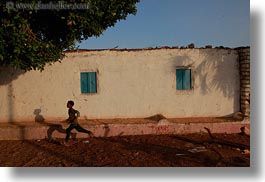 images/Africa/Egypt/NubianVillage/boy-running-by-bldg.jpg