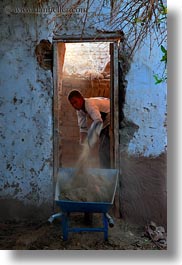 images/Africa/Egypt/NubianVillage/man-shoveling-in-doorway-01.jpg