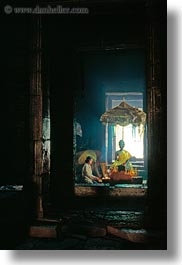 images/Asia/Cambodia/AngkorThom/Bayon/woman-lighting-candles-w-buddha.jpg