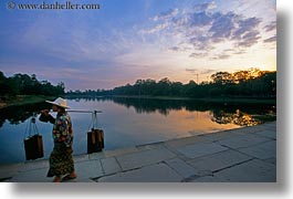 images/Asia/Cambodia/AngkorWat/Moat/woman-carrying-stuff-sunrise.jpg
