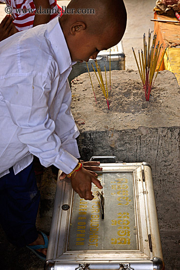 boy-placing-money-in-box.jpg