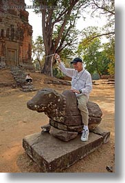 images/Asia/Cambodia/Bakong/man-on-stone-cow-1.jpg