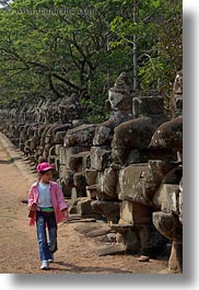 images/Asia/Cambodia/Gates/SouthGate/girl-in-pink-walking-by-statues-2.jpg