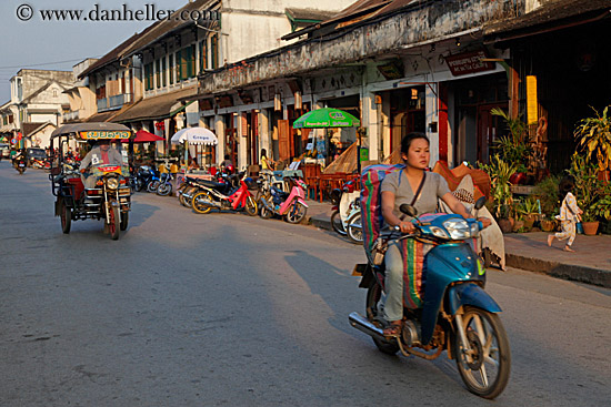 woman-on-blue-motorcycle-in-town.jpg