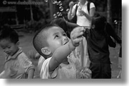 images/Asia/Laos/Villages/RiverVillage2/kids-playing-w-bubbles-3-bw.jpg