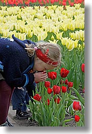 asia, childrens, colors, flowers, girls, moscow, nature, people, red, russia, smelling, tulips, vertical, yellow, photograph