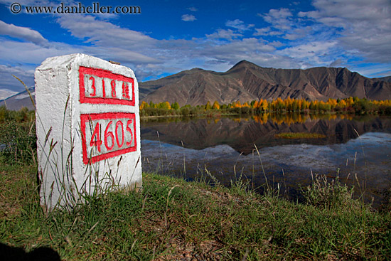 trees-reflection-mtns-n-clouds-n-sign.jpg