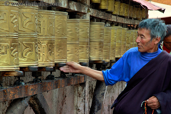 man-turning-prayer-cans.jpg