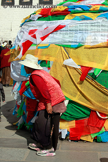 old-woman-walking-by-prayer-flags.jpg