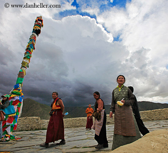 people-walking-by-prayer-flag-pole-01.jpg