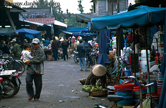 man-carrying-baby-in-market.jpg