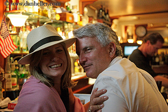 woman-in-hat-w-man-at-bar.jpg