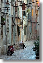 images/Europe/Croatia/Rovinj/Streets/man-sitting-by-motorcycle-on-narrow-street-2.jpg