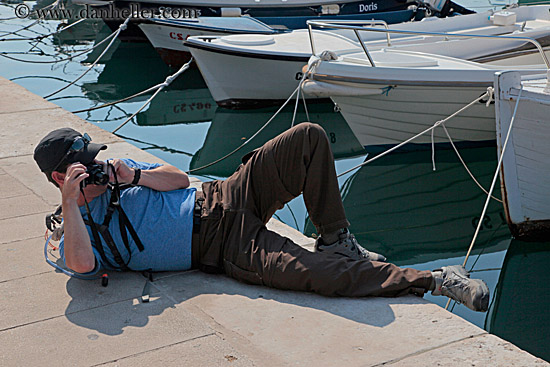 patrick-reclining-w-camera-by-boats-1.jpg