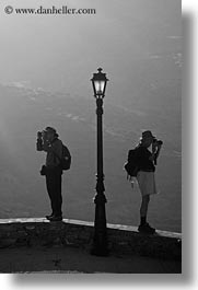 amorgos, black and white, europe, greece, lamp posts, people, photographers, vertical, photograph