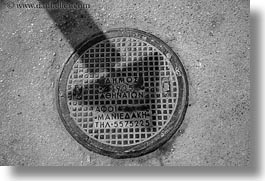 images/Europe/Greece/Athens/Streets/manhole-cover-n-arrow-shadow-bw.jpg
