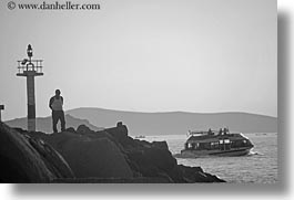images/Europe/Greece/Mykonos/Misc/man-on-rocks-watching-boat-bw.jpg