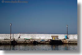 images/Europe/Greece/Mykonos/Misc/man-walking-on-stone-pier.jpg