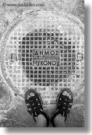 images/Europe/Greece/Mykonos/Misc/mykonos-manhole-cover-w-feet-bw.jpg