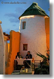 images/Europe/Greece/Naxos/Buildings/couple-dining-near-stucco-round-bldg.jpg