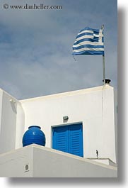 images/Europe/Greece/Naxos/Buildings/greek-flag-w-pot-on-stucco-bldg.jpg