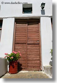 images/Europe/Greece/Tinos/DoorsWindows/old-brown-wood-door-n-pink-geraniums.jpg