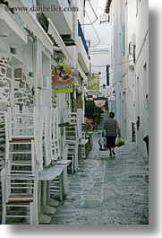 images/Europe/Greece/Tinos/Town/woman-walking-by-stacked-chairs.jpg