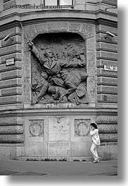 images/Europe/Hungary/Budapest/Art/woman-on-cell_phone-walking-by-communist-relief-1-bw.jpg