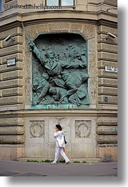 images/Europe/Hungary/Budapest/Art/woman-on-cell_phone-walking-by-communist-relief-2.jpg