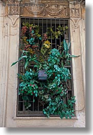 images/Europe/Italy/Puglia/Lecce/DoorsWindows/silk-plants-in-barred-window.jpg