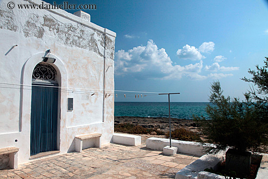 white-wash-house-n-clouds-over-ocean.jpg