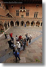 archways, bricks, downview, europe, jagiellonian university, krakow, looking, materials, people, perspective, poland, structures, vertical, photograph