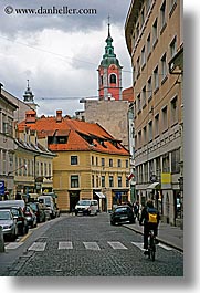 bicycles, buildings, cities, clouds, cyclists, europe, ljubljana, slovenia, streets, towns, vertical, photograph