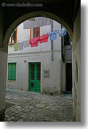 archways, clothes, cobblestones, europe, hangings, laundry, pirano, slovenia, vertical, windows, photograph