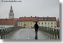 bridge, europe, horizontal, men, ptuj, rain, slovenia, walking, photograph