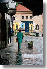 cobblestones, europe, ptuj, rain, slovenia, umbrellas, vertical, walking, womens, photograph