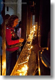 images/MiddleEast/Israel/Jerusalem/ReligiousSites/HolySepulchre/woman-lighting-candles.jpg