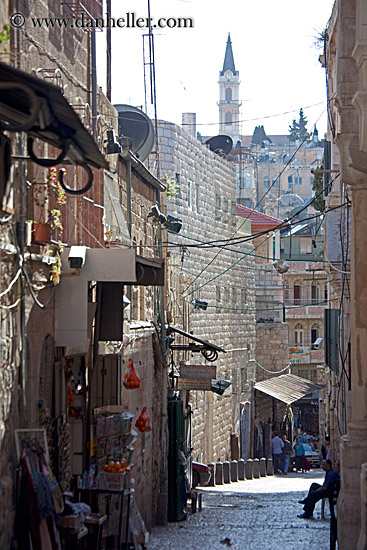 man-sitting-on-narrow-street.jpg